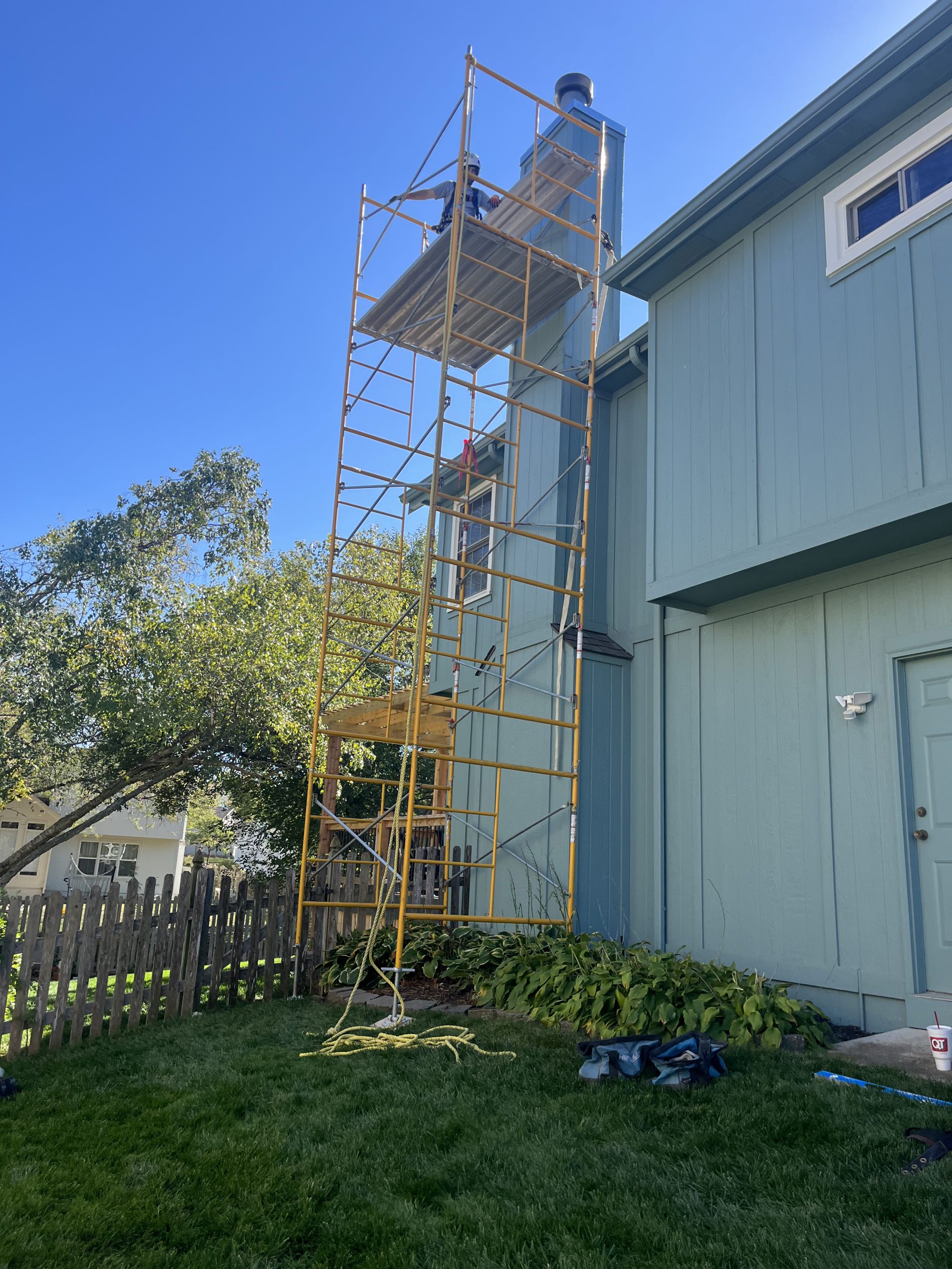 Repairing Chimney Chase with scaffolding on 2 story home in Kansas City