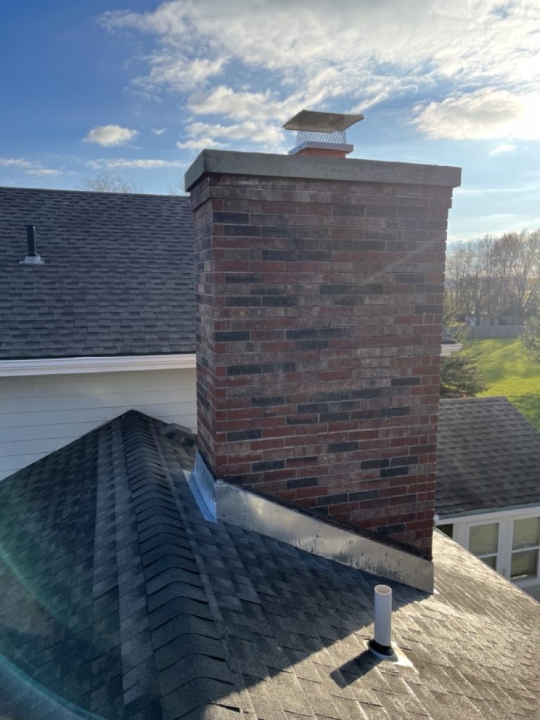 Brick chimney with chimney crown and flue cap