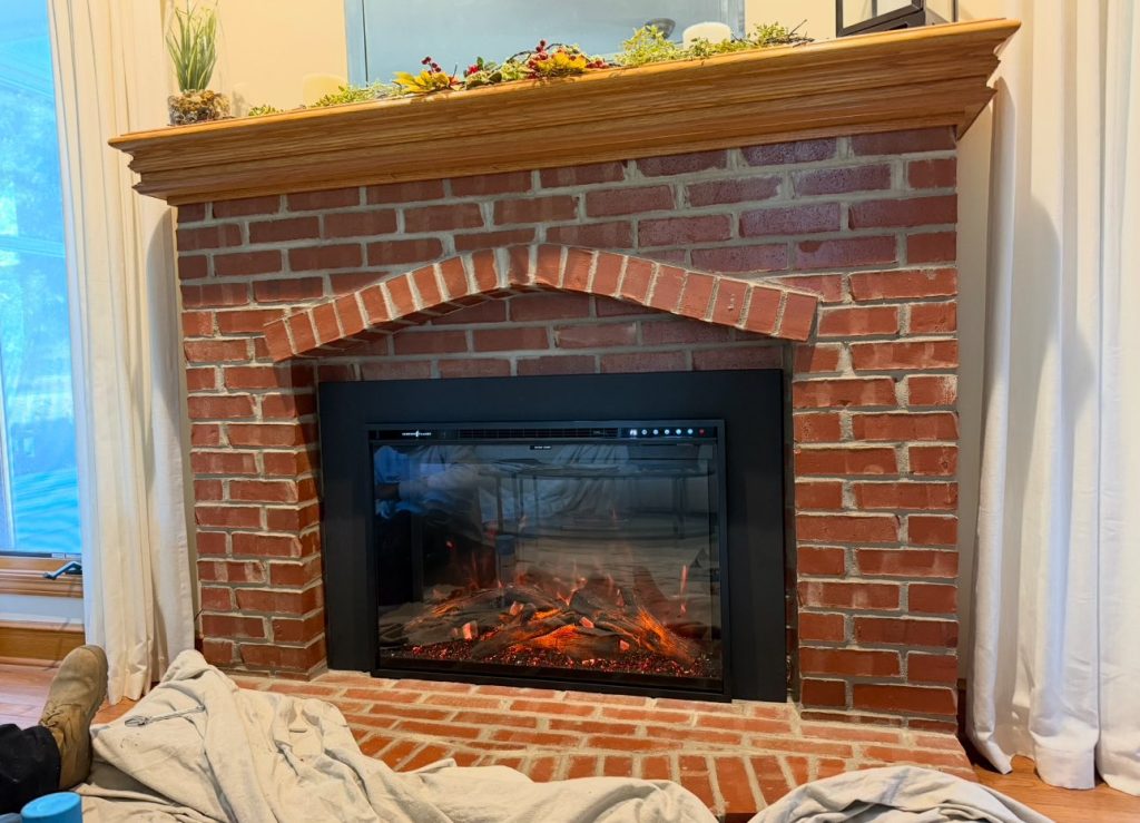 Completed fireplace remodel and new fireplace insert installation in Leawood, KS home by Chimney Restoration of Kansas City
