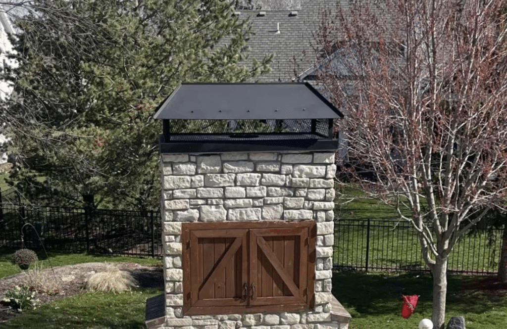Custom Fabricated Chimney Caps Installation on Outdoor Fireplace in Kansas City