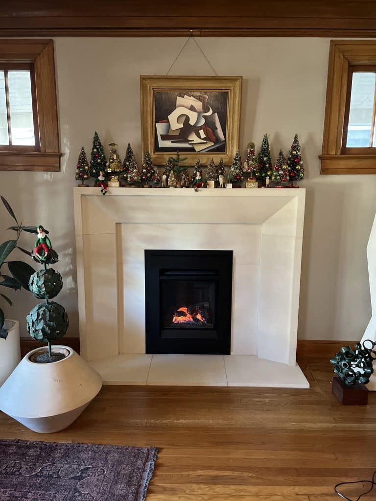 Modern fireplace insert installation with custom white surround in a Kansas City home by Chimney Restoration of KC Fireplace Installers
