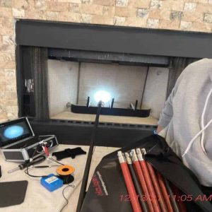 Chimney Sweep and Camera Inspection in Lenexa KS Home with chimney poles and camera equipment to see inside flue