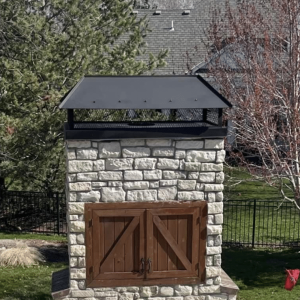 Custom Fabricated Chimney Caps Installation on Outdoor Fireplace in Kansas City