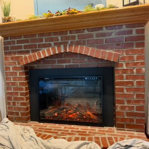 Completed fireplace remodel and new fireplace insert installation in Leawood, KS home by Chimney Restoration of Kansas City
